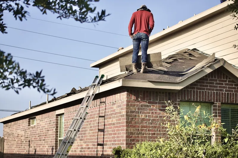 Professional roofer working on a residential roof in Canton Junction
